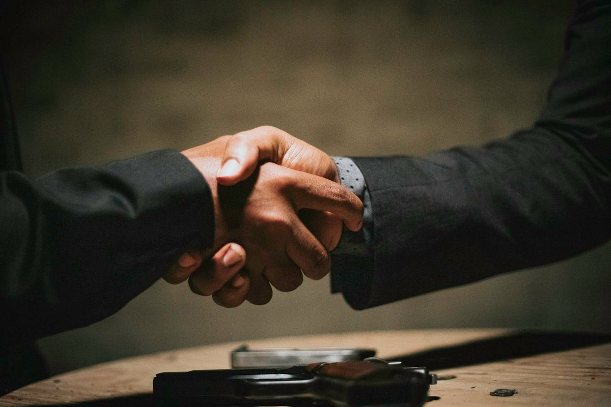 Handshake over a wooden table