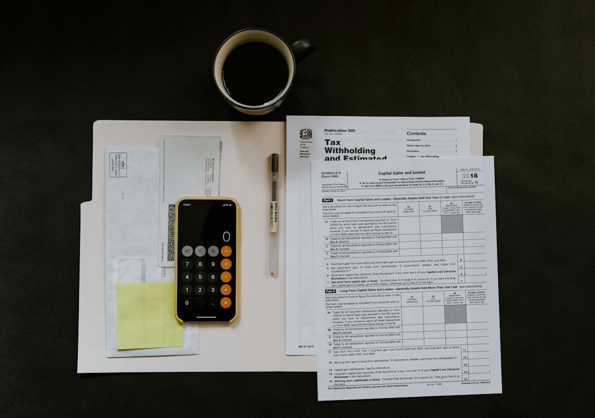 Tax paperwork with pen and smartphone
